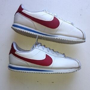 Nike White Sneakers with Red Swoosh and Blue Accent